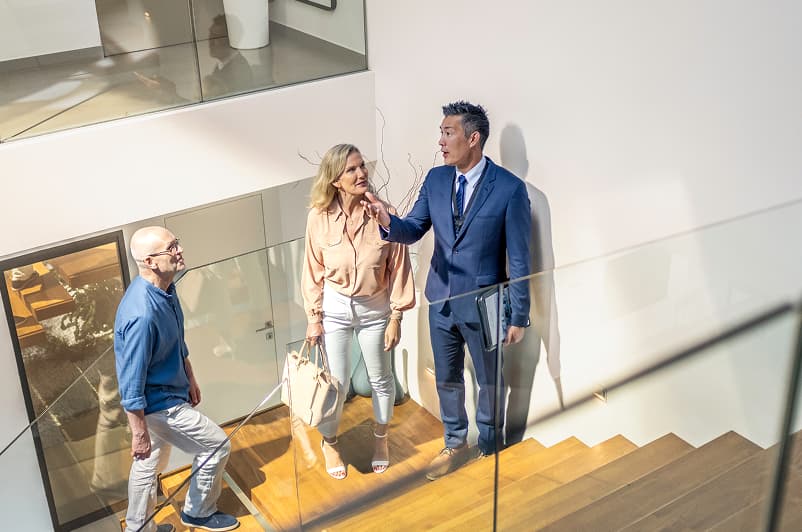 luxury home living room with fireplace, piano, couches, lots of windows and light and high ceilings